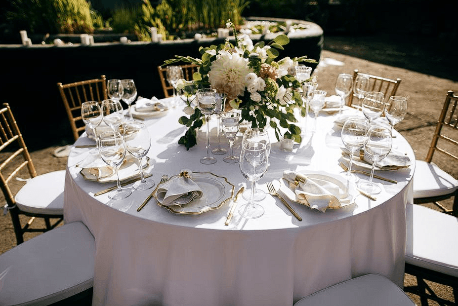 Elegant corporate dinner setting with white florals