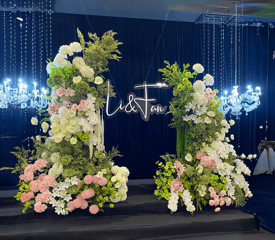 Modern corporate event entrance with lush green arrangements